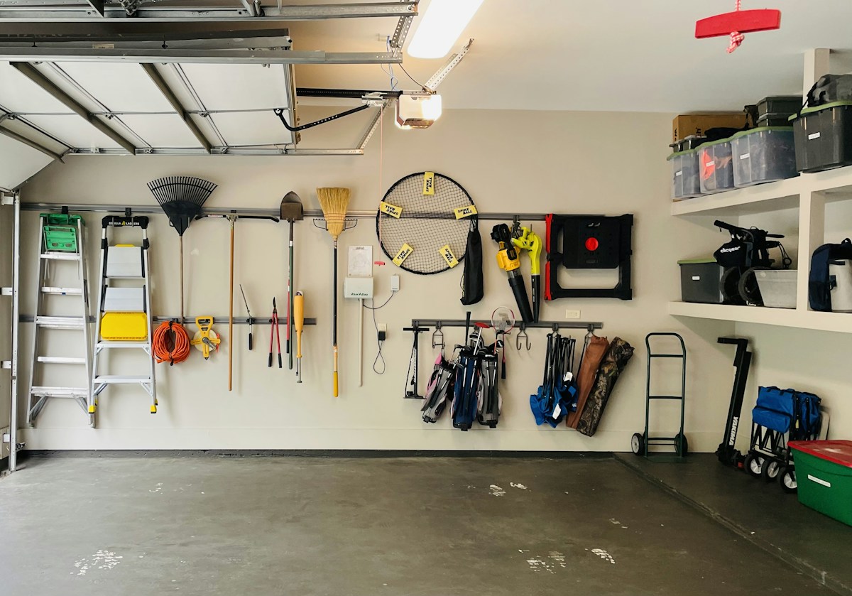 Garage with neatly arranged storage shelves, containers and equipment